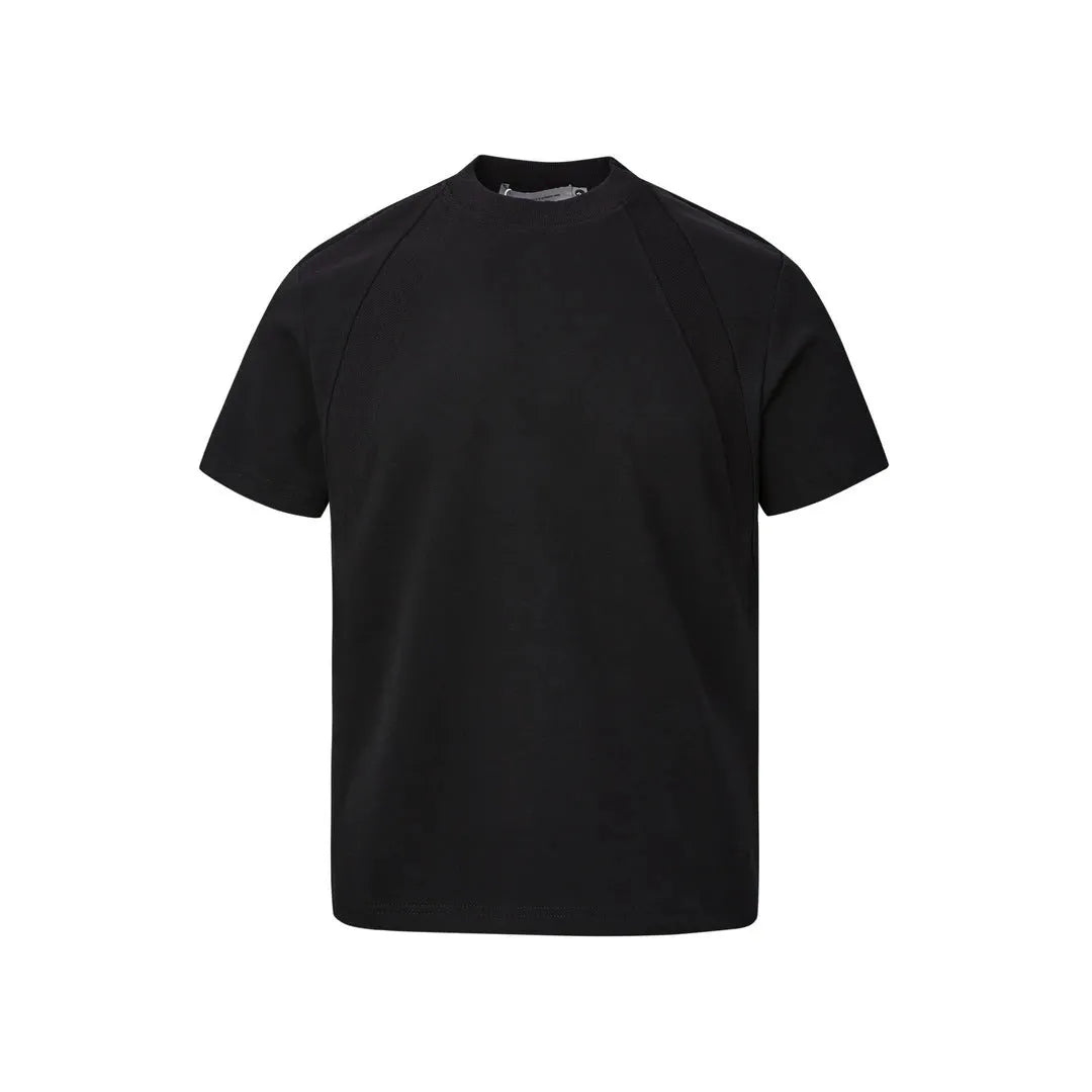 Man wearing a loose fit grey short sleeve top with visible air layer stitching texture.