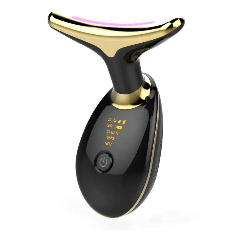 White EMS thermal neck massager device with LED lights on a stand next to USB cable and moisturiser.