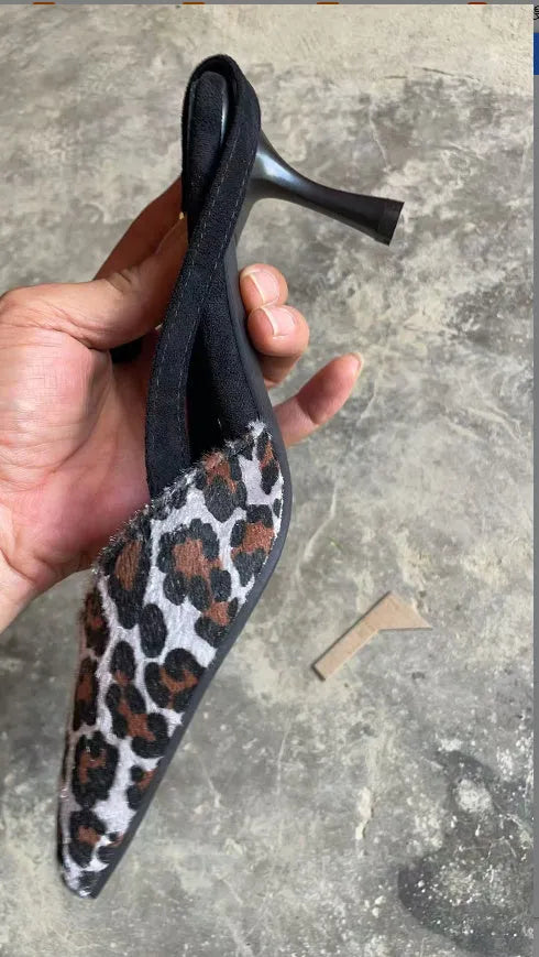 Women's leopard print suede sandals with a pointed toe on a white background.