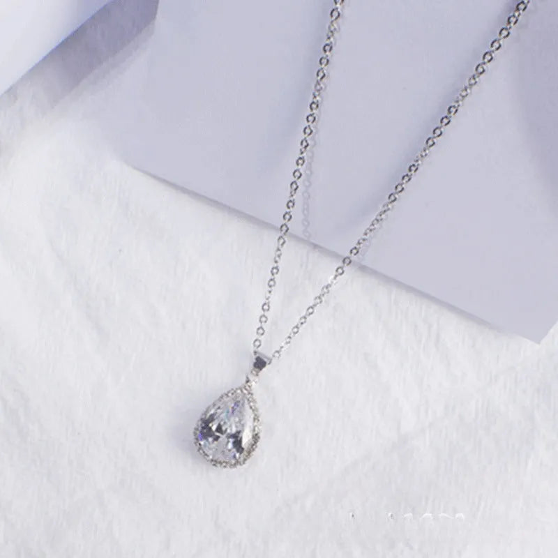 Pink drop shape women's necklace with geometric pendant design and rhinestone details