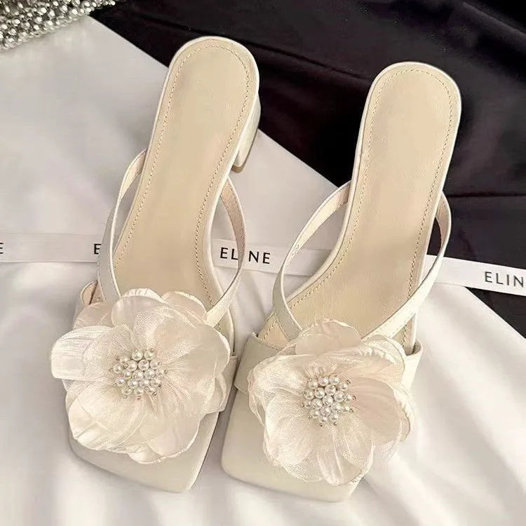 Beige women's sandals with a chunky heel, square toe, and a single satin strap across the foot.