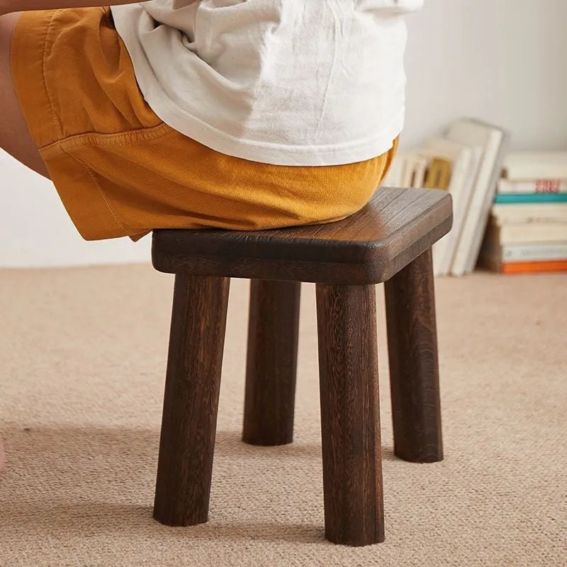 Distressed brown wooden stool with bracket legs for changing shoes