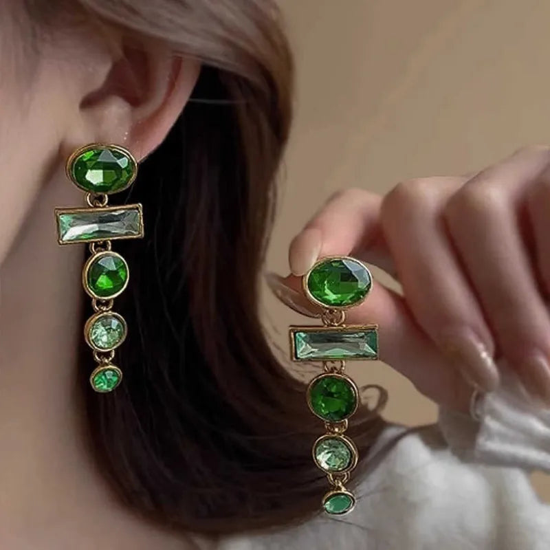 A pair of green gradient geometric alloy earrings with tassels and a zircon stone, shown on a white background.
