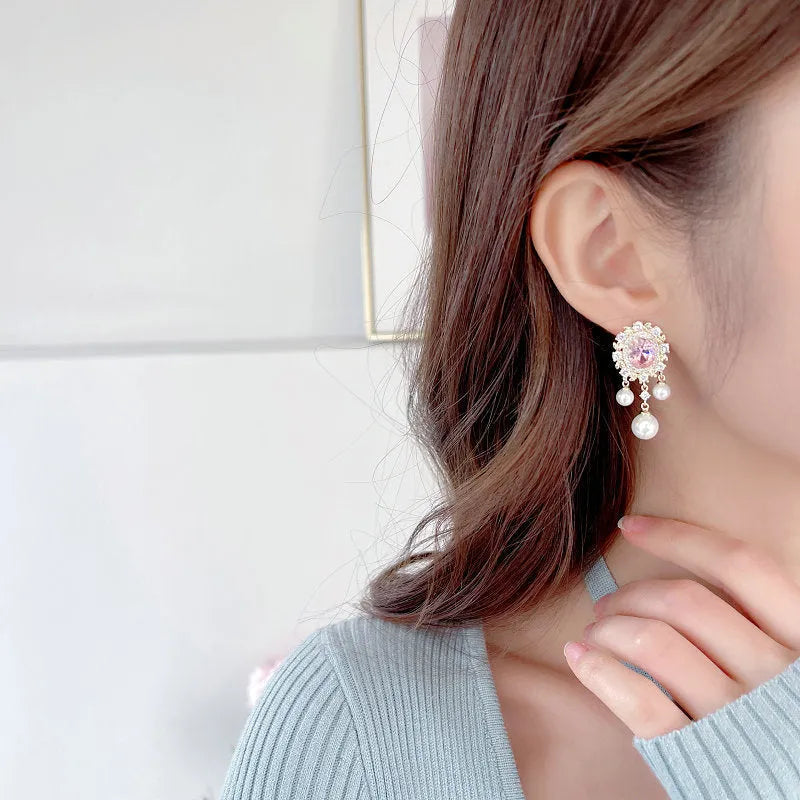 Oval zircon inlaid pearl tassel earrings with geometric design and decorative hanging elements