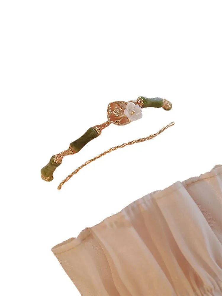 Natural olivine women's bracelet with a double layer twin bells of ireland charm and olive branch detail.