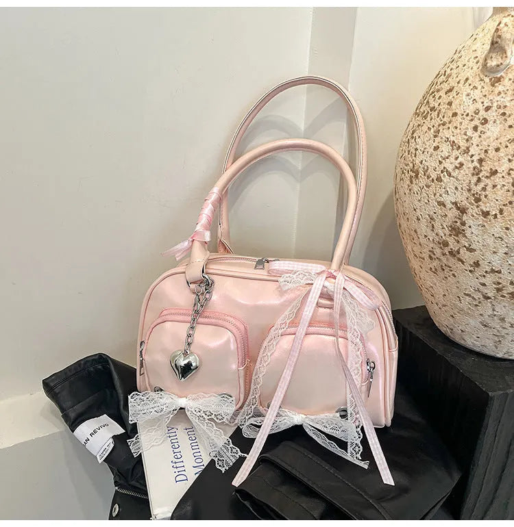 Casual shoulder bag in horizontal square design with cross-body strap, showing internal mobile phone pocket organisation