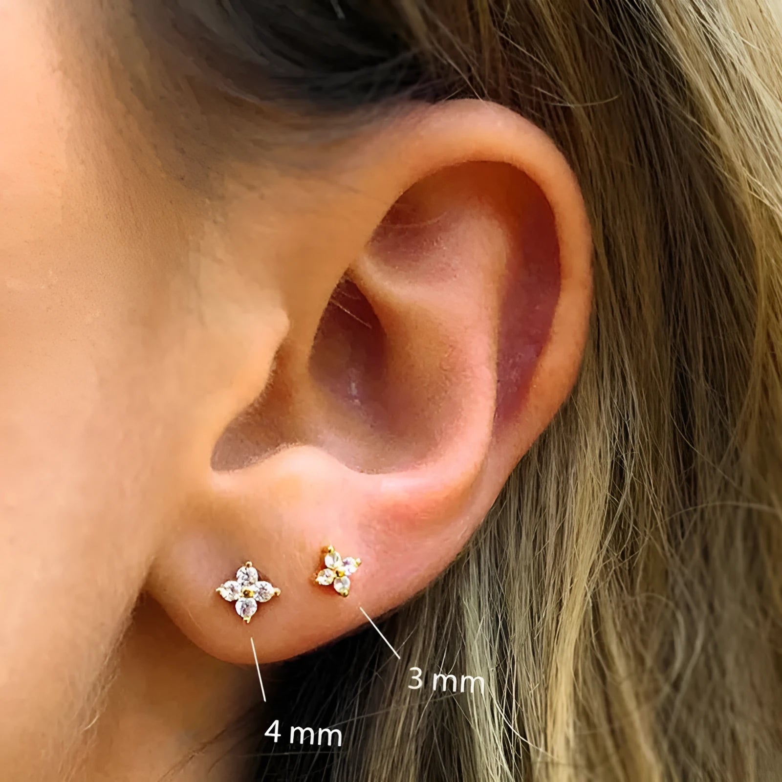 S925 sterling silver stud earrings with a geometric petal and crystal flower design in gold and platinum finishes.
