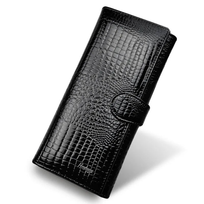 Women's patent leather purse with crocodile pattern in red colour showing pigskin lining interior