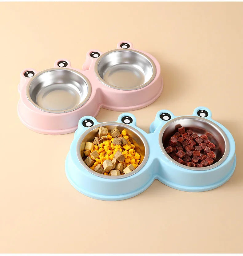 Blue stainless steel double pet bowl with frog design, showing separate food and water compartments on a non-slip base.
