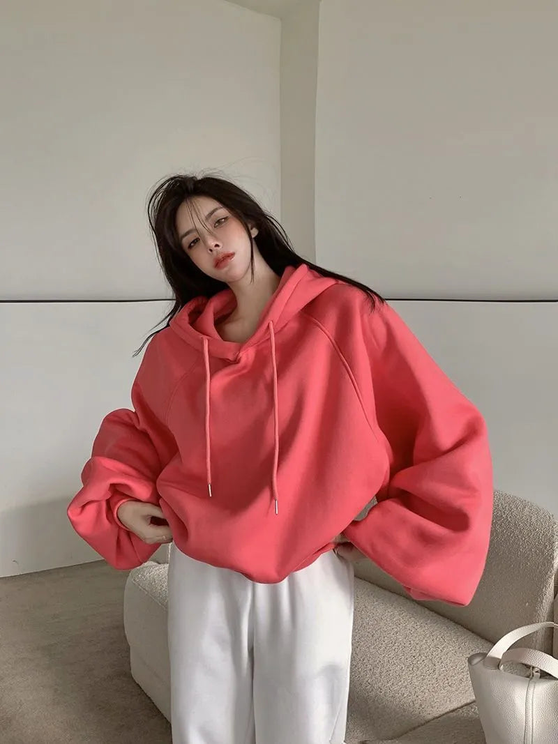Watermelon red mulberry silk sleeveless hooded sweater on hanger showing loose fit and hood detail