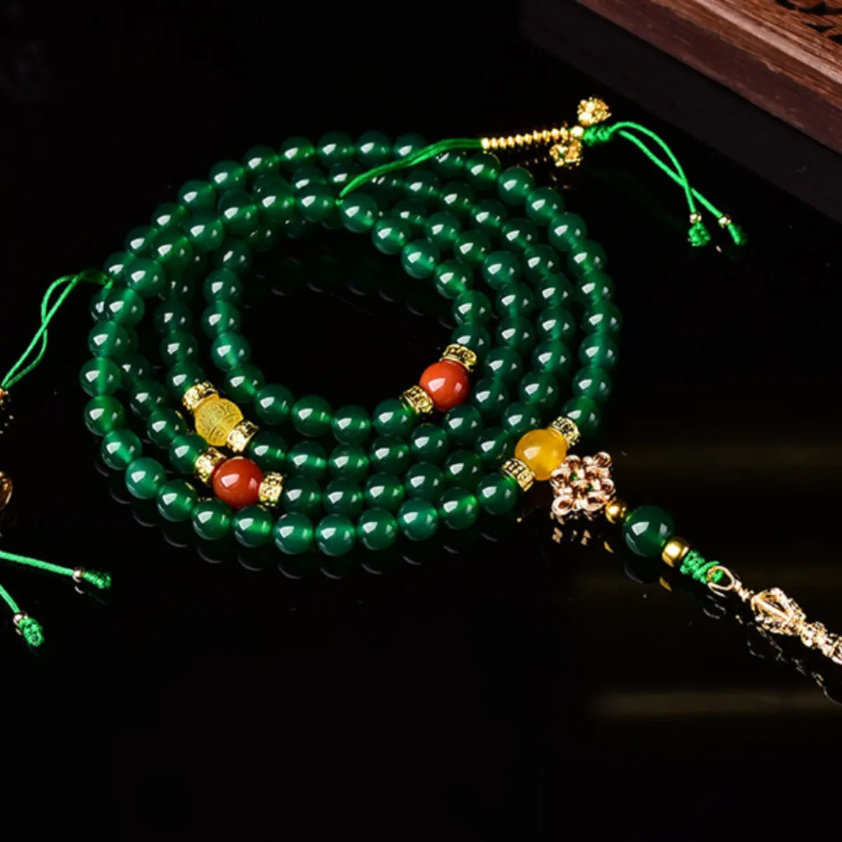 Multi-strand green agate bracelet for men and women on wrist, showing natural stone beads.