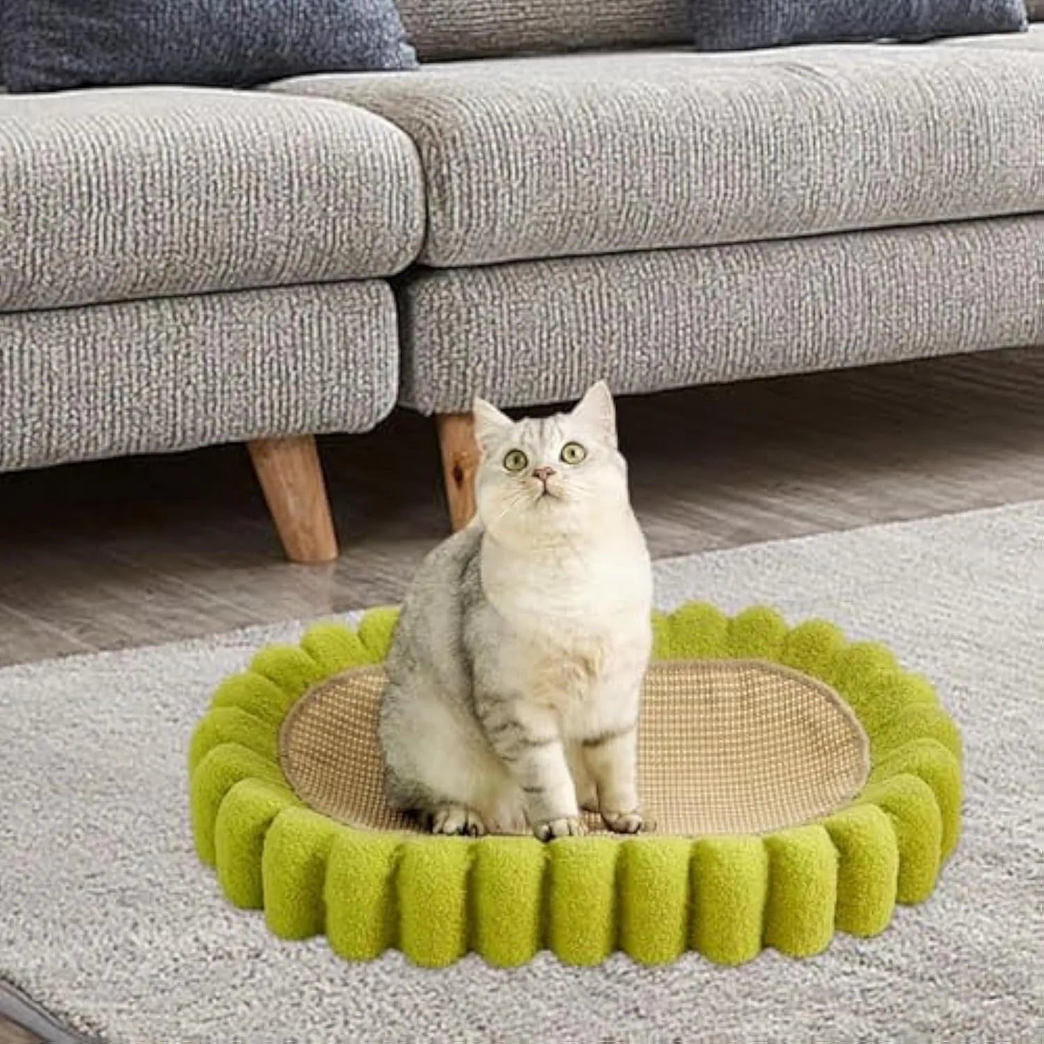 Green oval-shaped cat scratcher pad made of sisal, functioning as both a scratching surface and a lounge bed for cats.