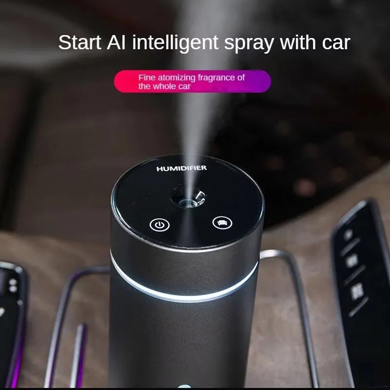 Black aluminium car humidifier diffuser with night light on a desk next to USB cable