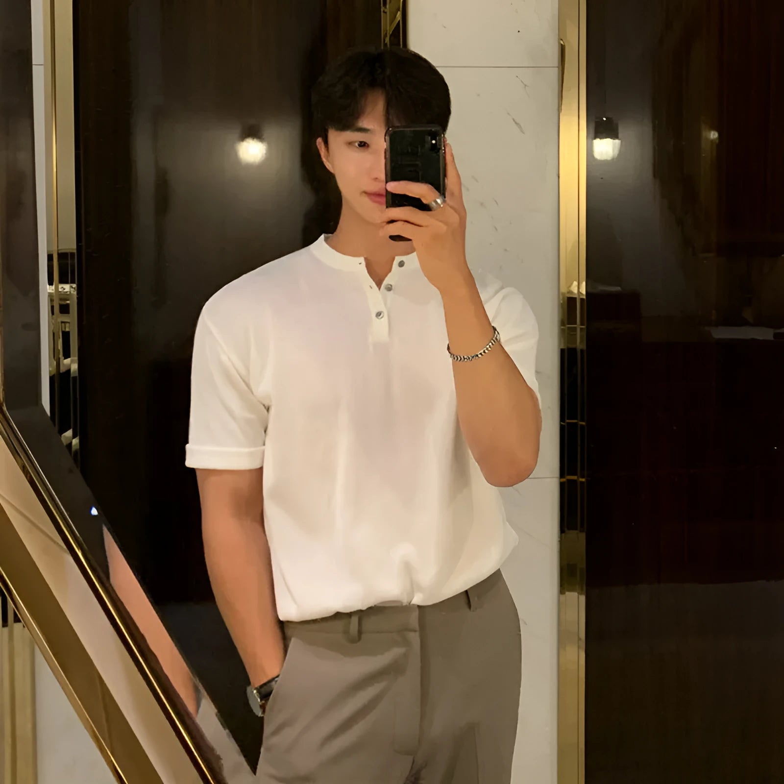Men's black thin slim-fit ice silk knitted short-sleeved shirt on a hanger.