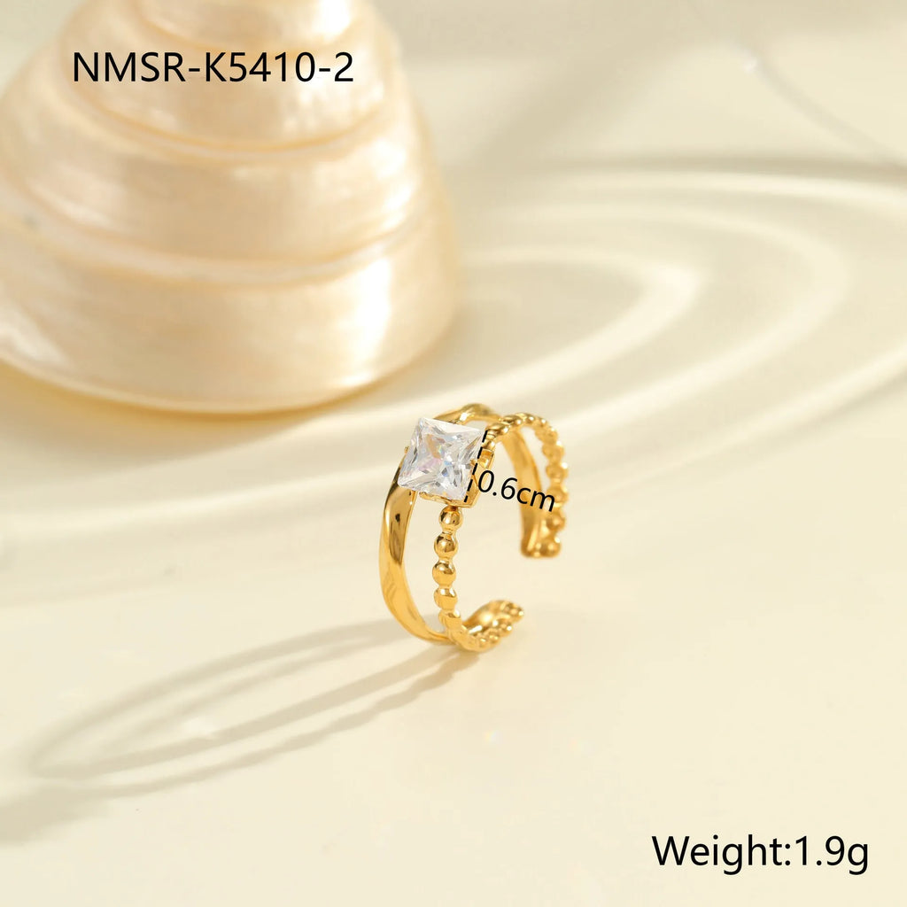 Gold electroplated stainless steel ring with zircon detailing and open mouth adjustable design