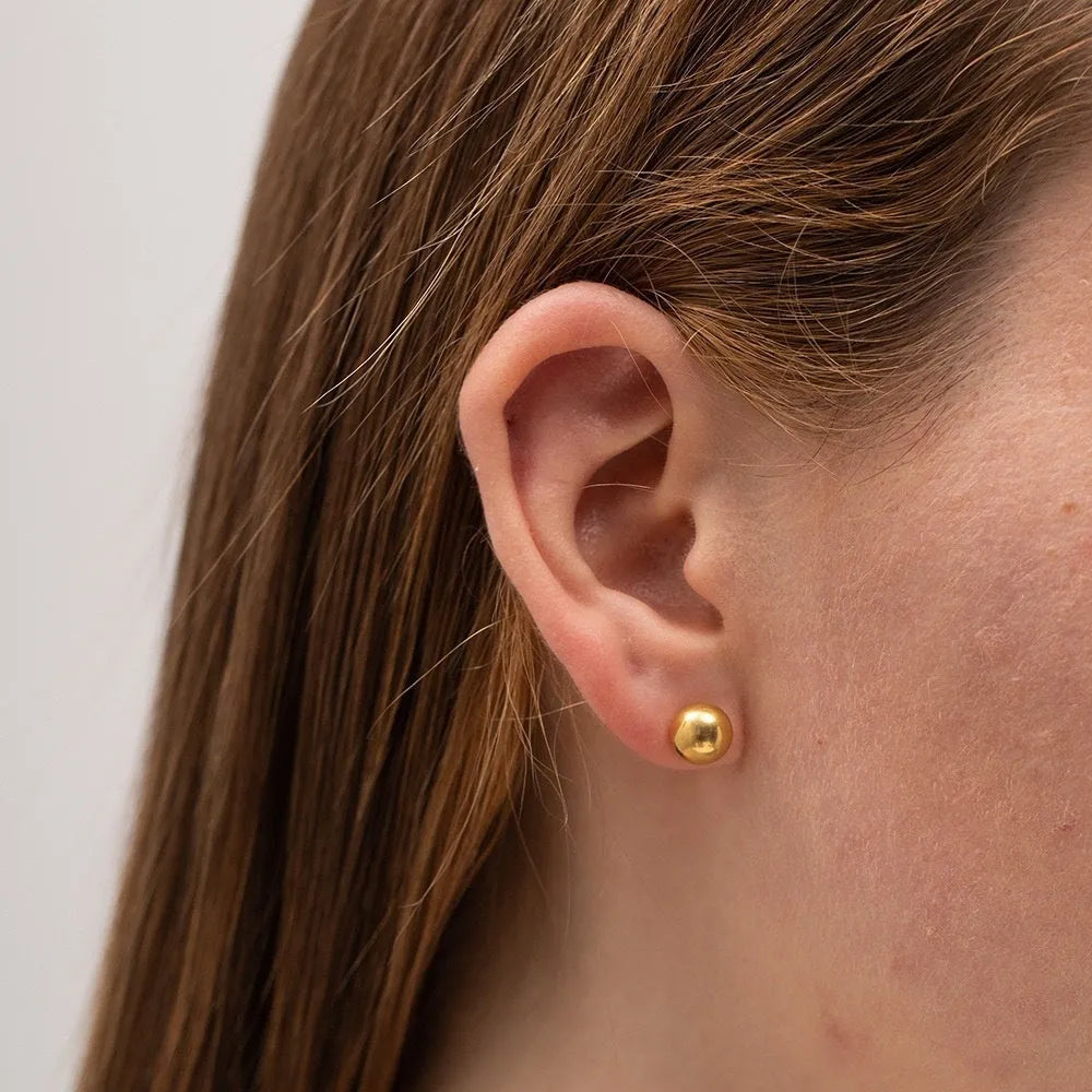 Stainless steel ball stud earrings in gold and silver, shown in 3mm, 4mm, 5mm, and 6mm sizes