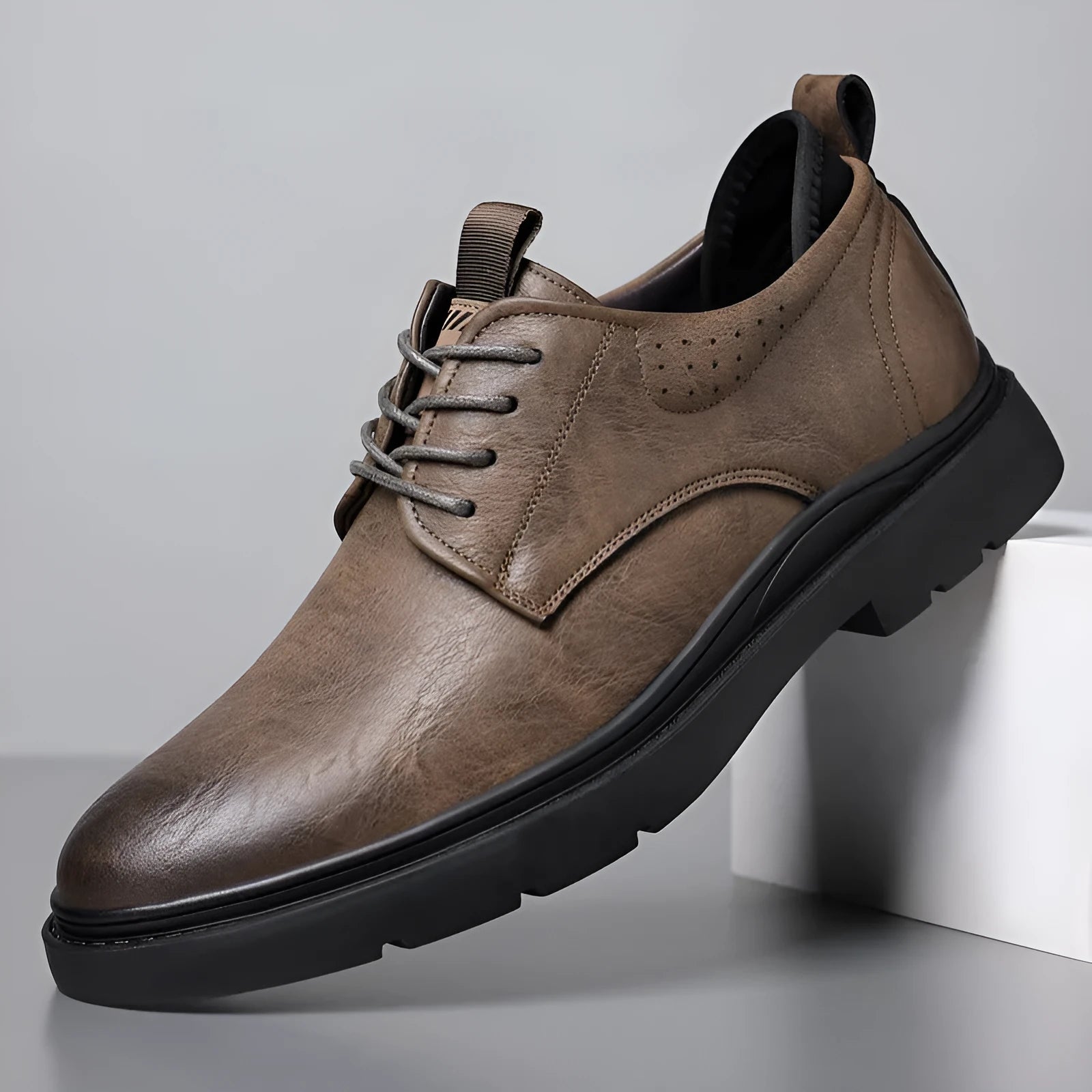 Men's black and brown leather casual sneakers with decorative stitching and a rubber sole.