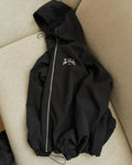 Grey loose fit men's hooded sunscreen jacket in British style on a middle-aged model.