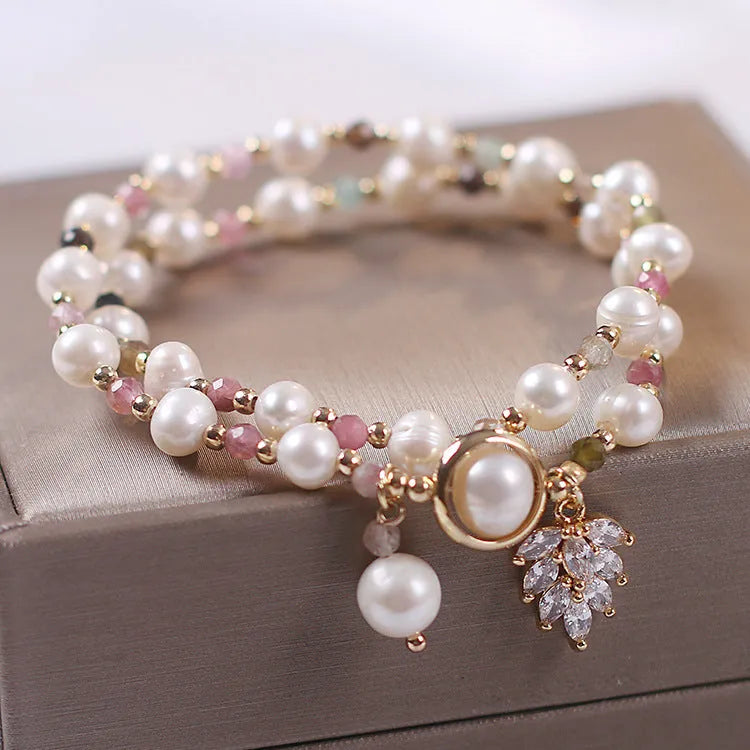 Women's double layer crystal bracelet with lucky cat charm and red cat's eye flowers.