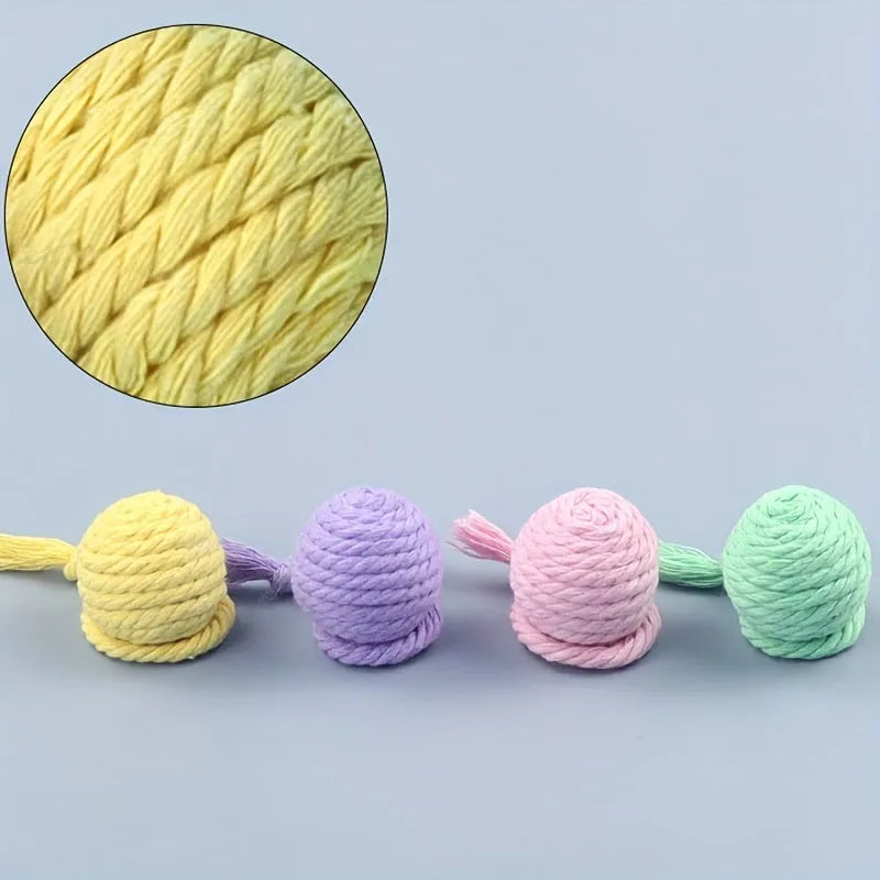 Cat toy ball with rope and bell inside in green, pink, purple, and yellow colours