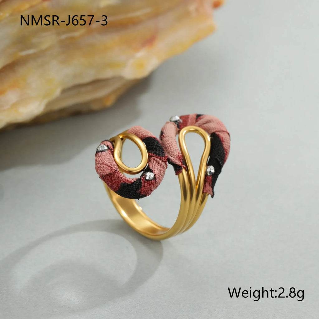 Leopard print geometric open mouth ring on a finger, showing heart shape and adjustable stainless steel band.