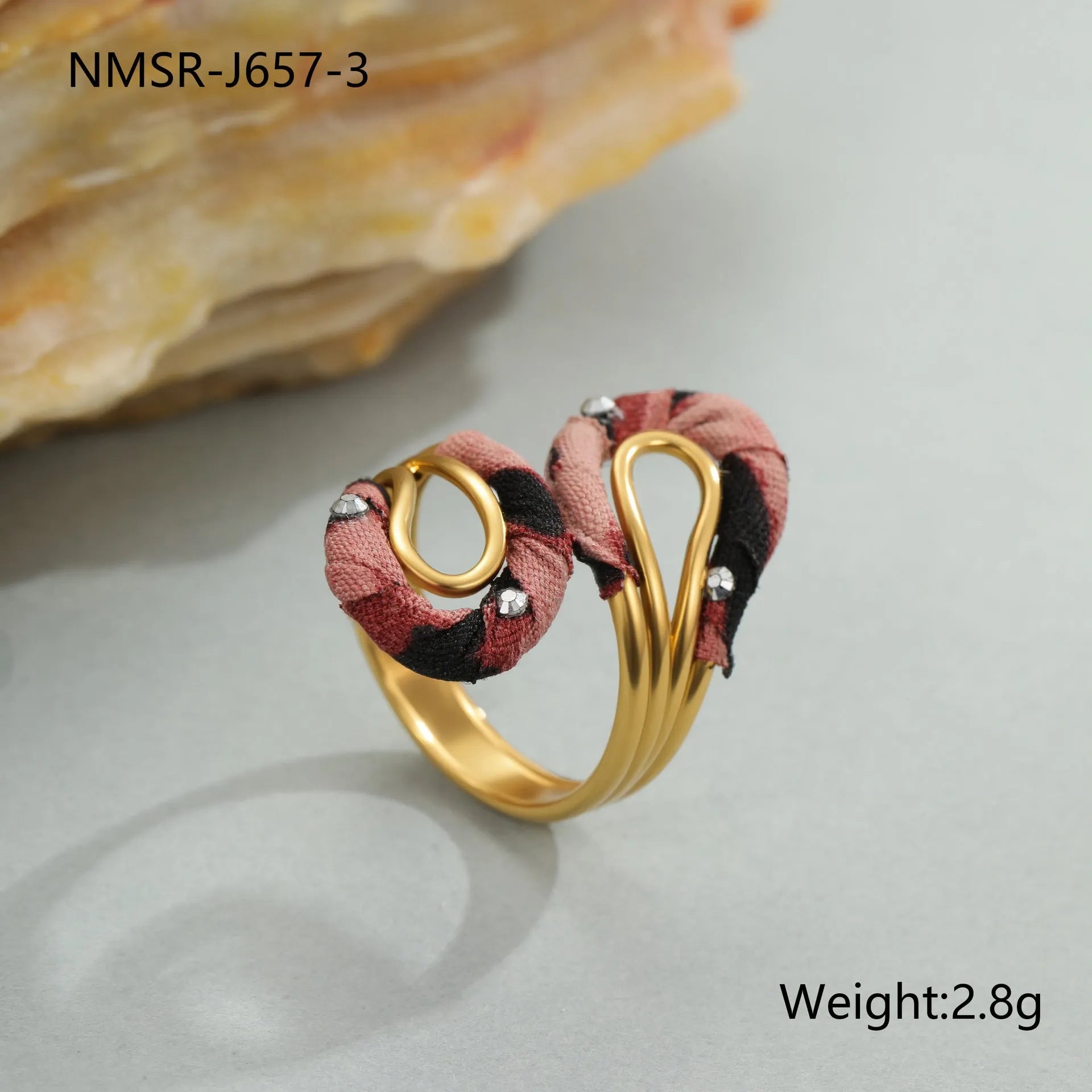 Leopard print geometric open mouth ring on a finger, showing heart shape and adjustable stainless steel band.