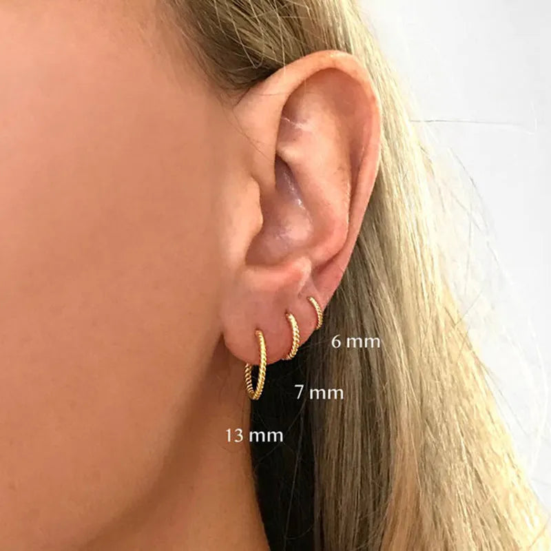 Sterling silver twisted round earrings in gold or white gold finish showing geometric design and S925 marking