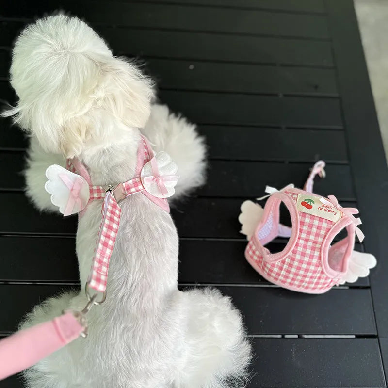 Small dog wearing pink cotton chest and back harness with integrated hand holding rope