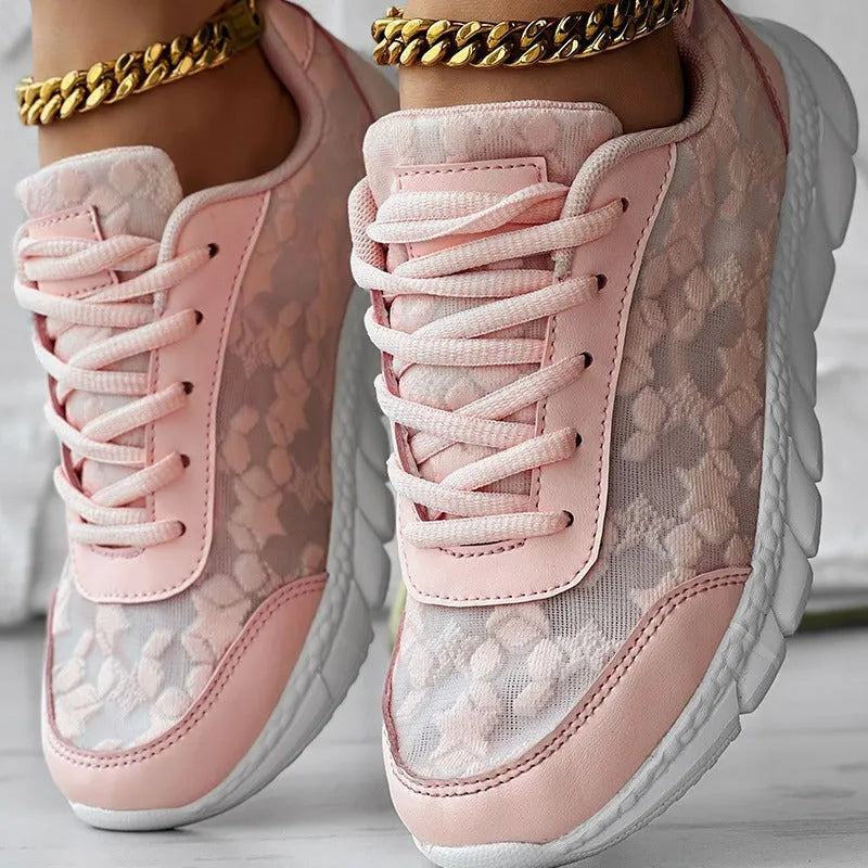 Women's canvas running shoes in white, black, blue, and pink colours with flat-heel construction
