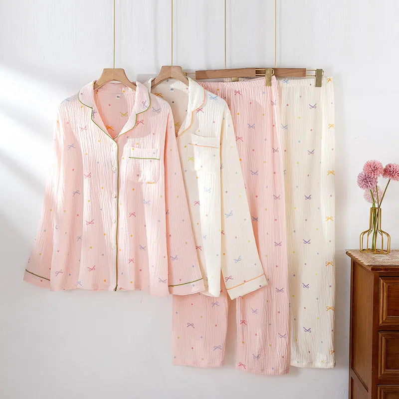 Women's long sleeve cotton pajama set in pink, featuring a top and trousers for sleepwear.