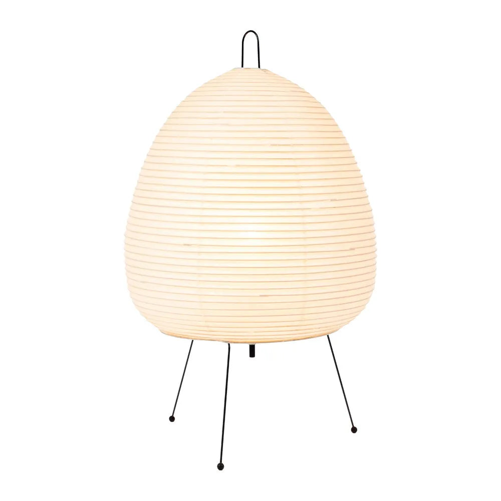 Japanese style rice paper table lamp with aluminium base on a wooden table.