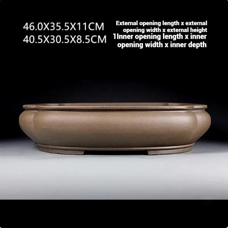 Handmade antique papaya-shaped purple clay flower pot, 46cm long, on a wooden surface.