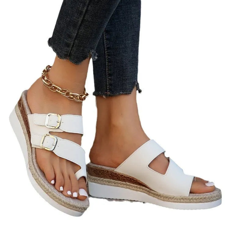 White women's wedge sandals with a woven patent leather upper, peep toe, and a finger-fit ankle strap on a rubber sole.