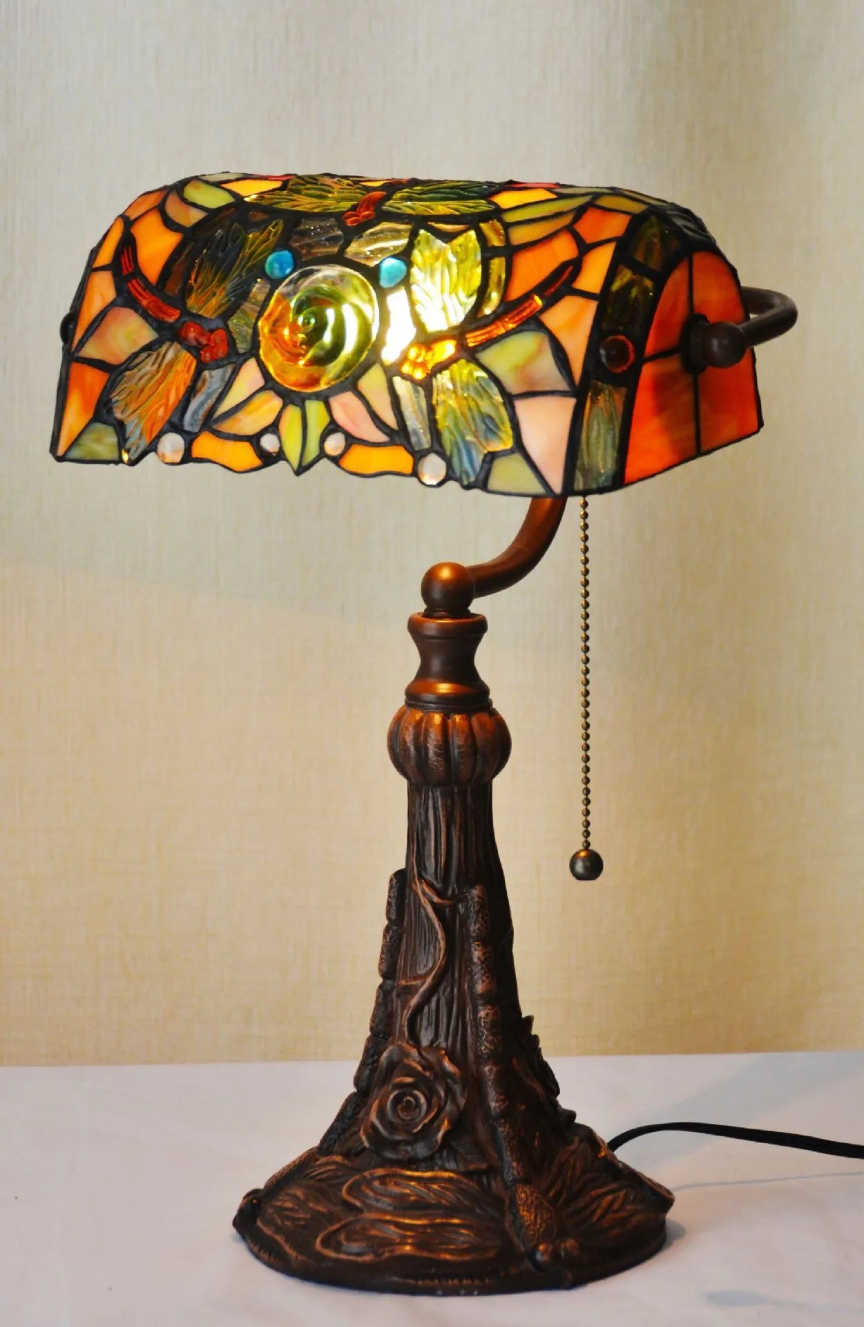 10-inch Tiffany table lamp with stained glass design and resin base on wooden desk