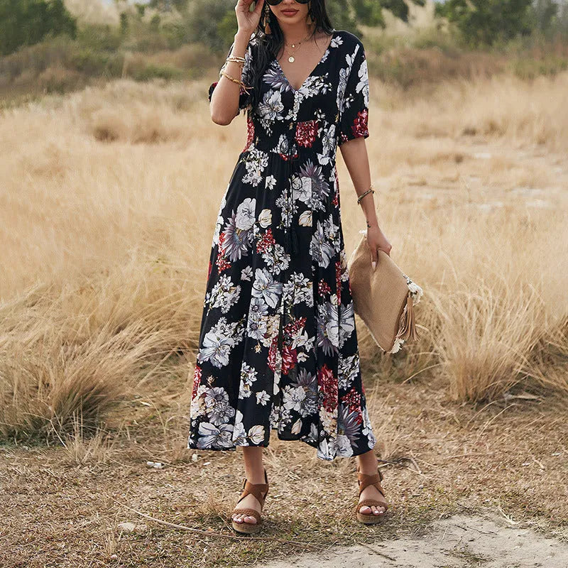 Women's floral print beach dress with V-neck, short sleeves, elastic waist, and mid-length skirt.