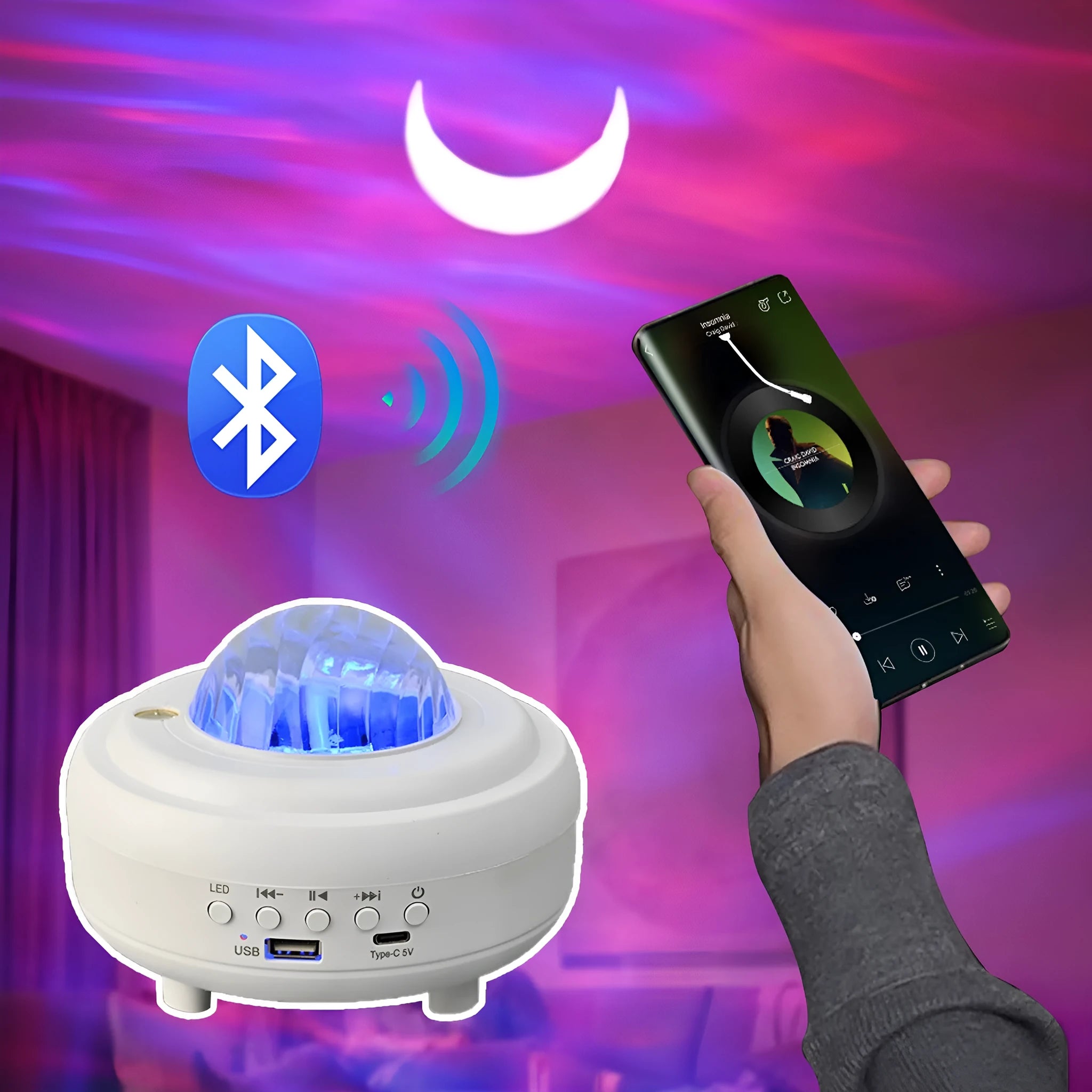 White galaxy star projector night light with Bluetooth speaker showing star projection on wall