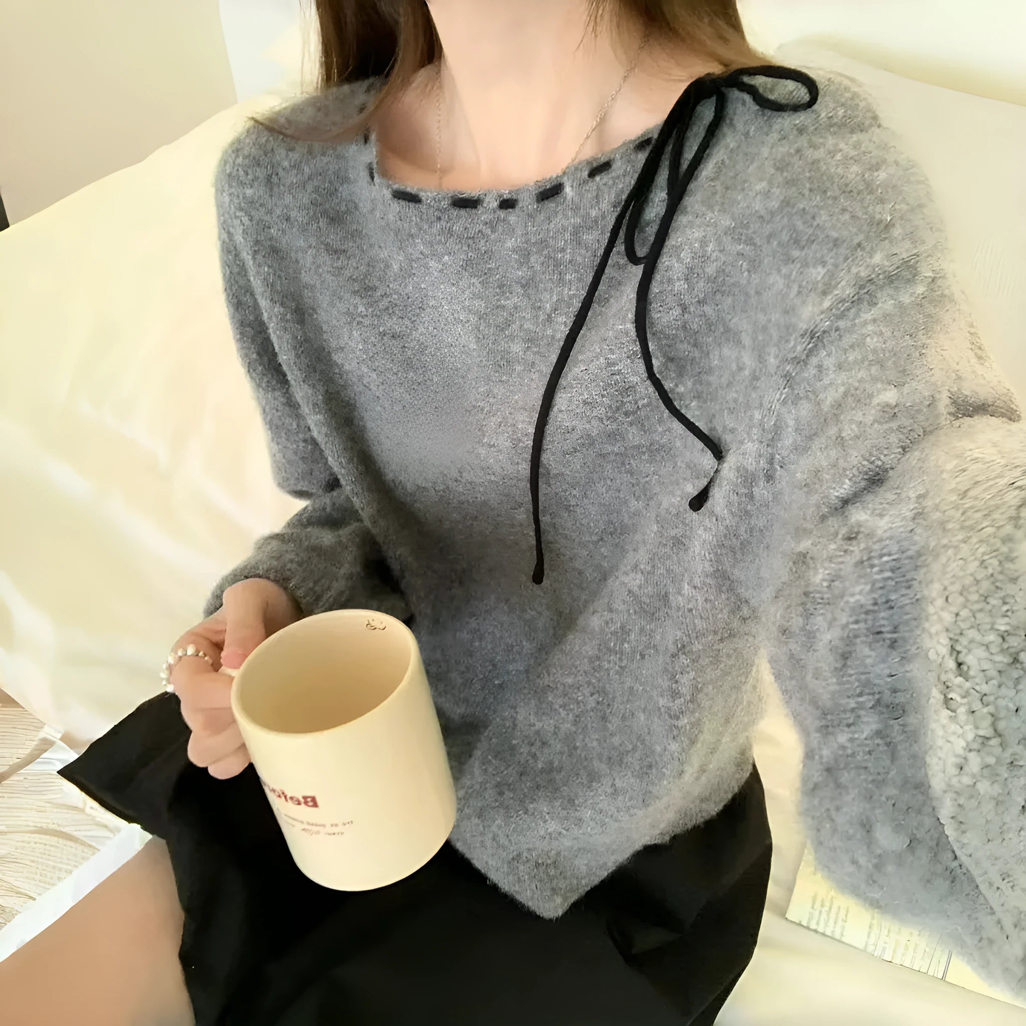 Women's loose grey knitwear pullover jumper on a hanger