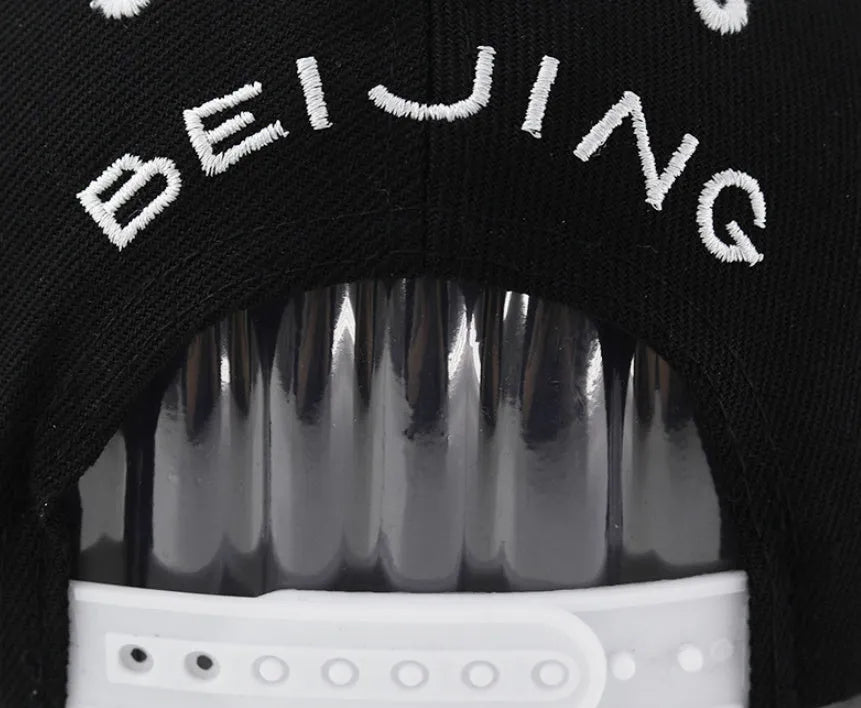Cotton baseball cap with embroidered letters, adjustable strap, in black or white