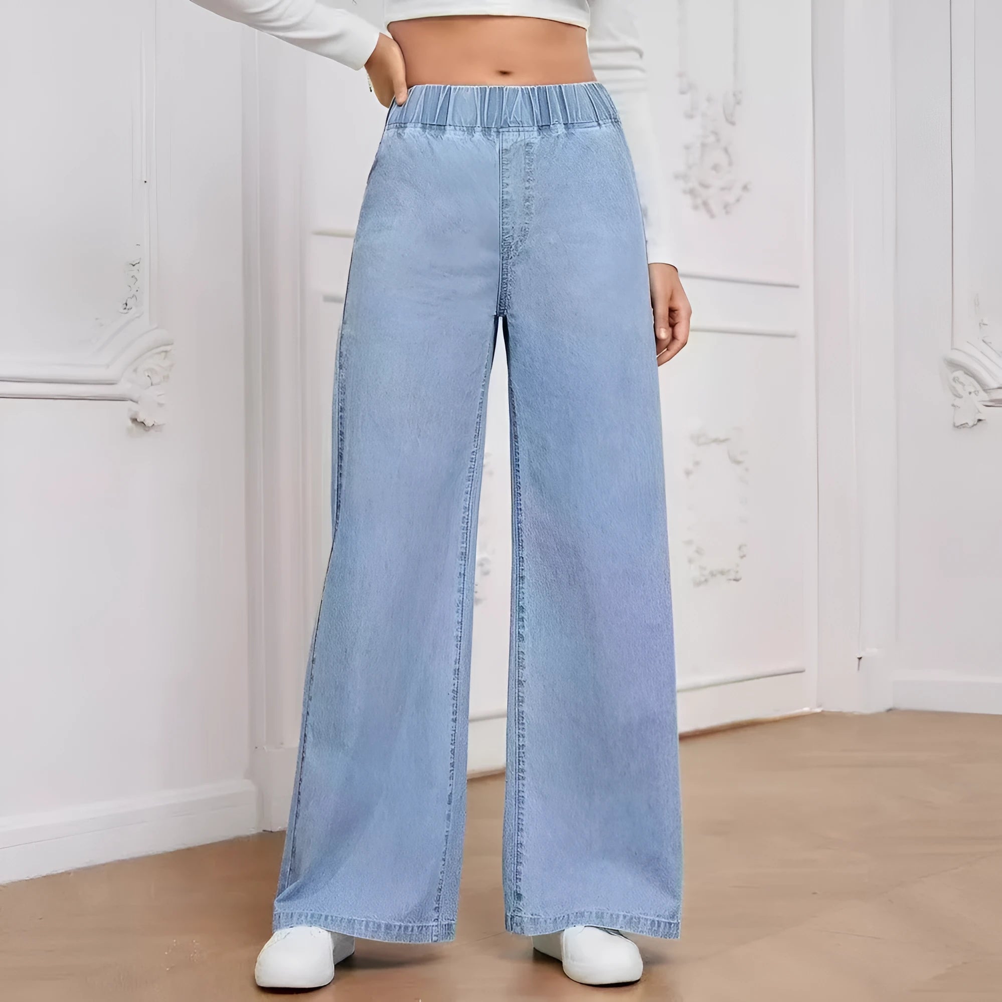 Plus size light blue washed wide-leg straight-leg jeans on a hanger.
