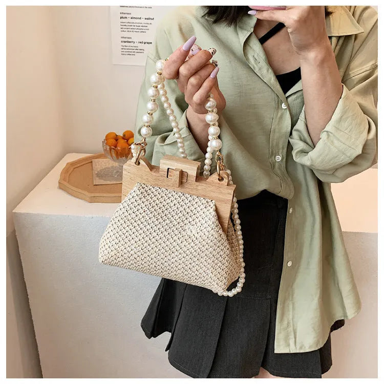 Women's straw woven shoulder bag with pearl chain detail in horizontal square shape