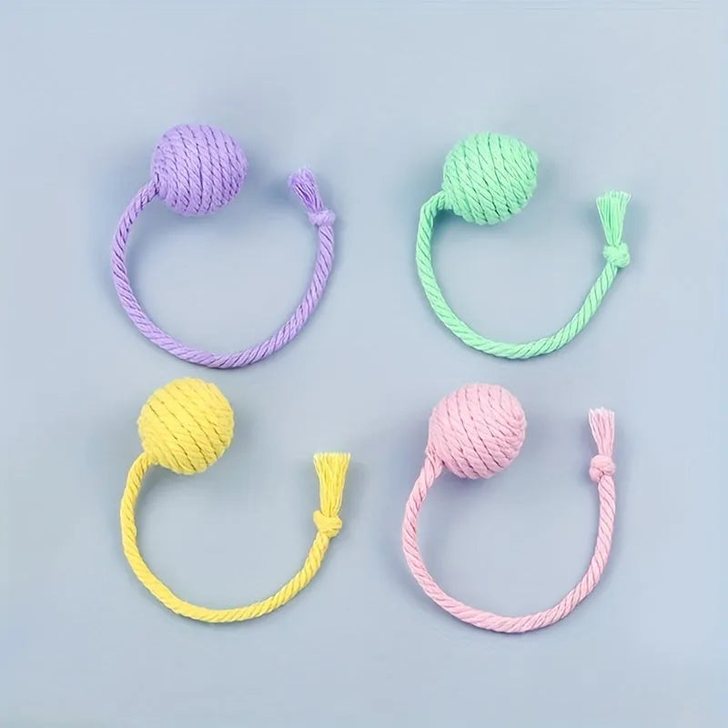 Cat toy ball with rope and bell inside in green, pink, purple, and yellow colours