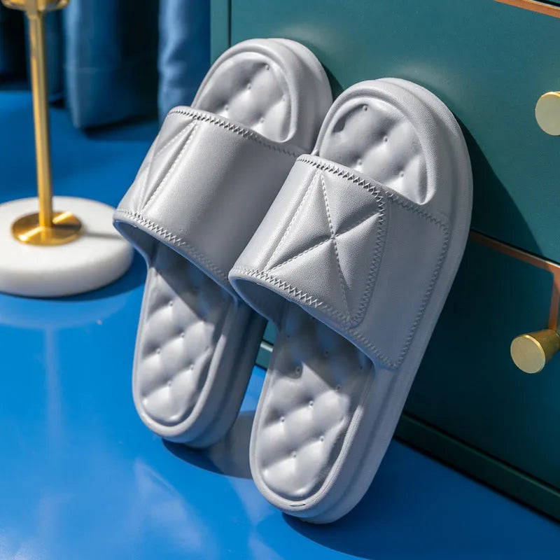 A pair of thick-sole EVA bathroom slippers in a choice of five colours, shown on a bathroom floor.
