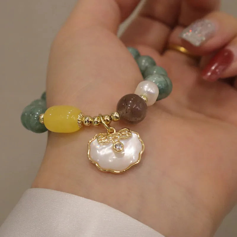 Natural green jade and shell bead bracelet with adjustable cord for women.