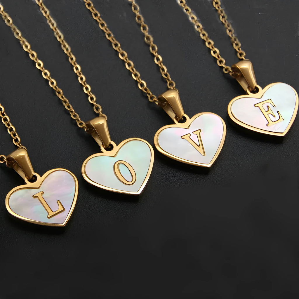 Gold-plated heart necklace with white shell centre on an adjustable stainless steel chain.