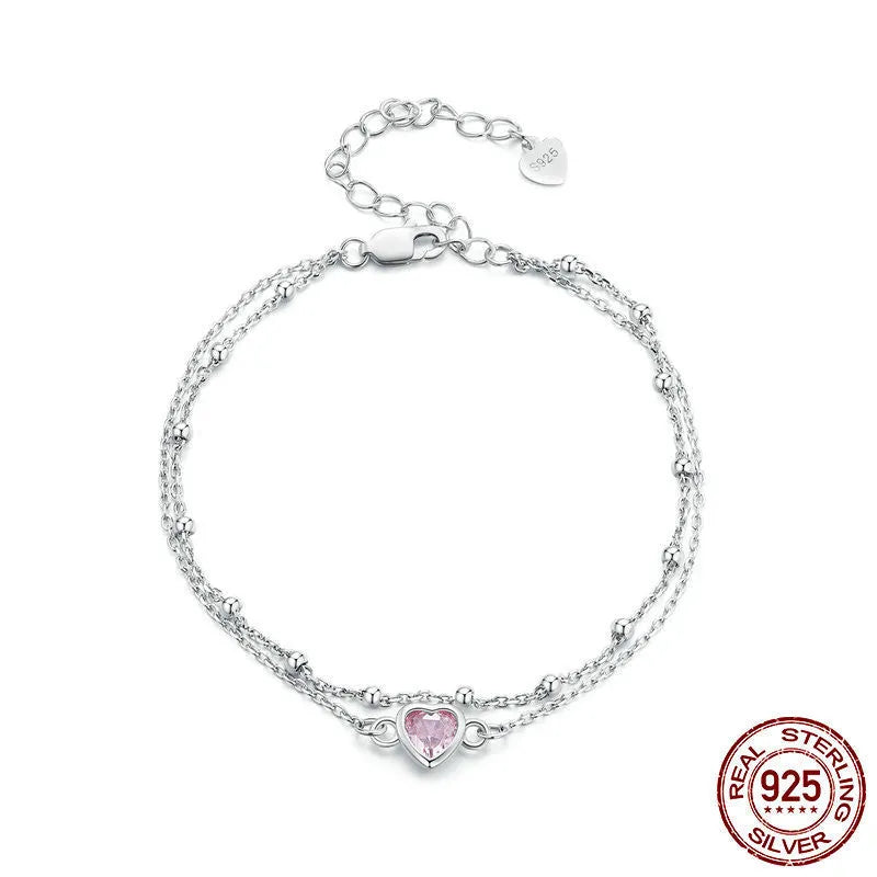 Women's sweet style sterling silver bracelet with a small heart-shaped charm on an adjustable chain.