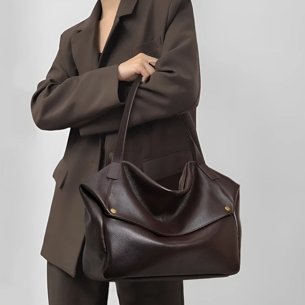 Brown genuine leather women's shoulder bag with a horizontal square shape and shoulder strap.
