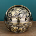 Bronze alloy ashtray with decorative pattern and integrated smoke extinguishing slot.
