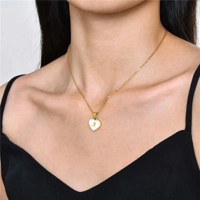 Gold-plated heart necklace with white shell centre on an adjustable stainless steel chain.