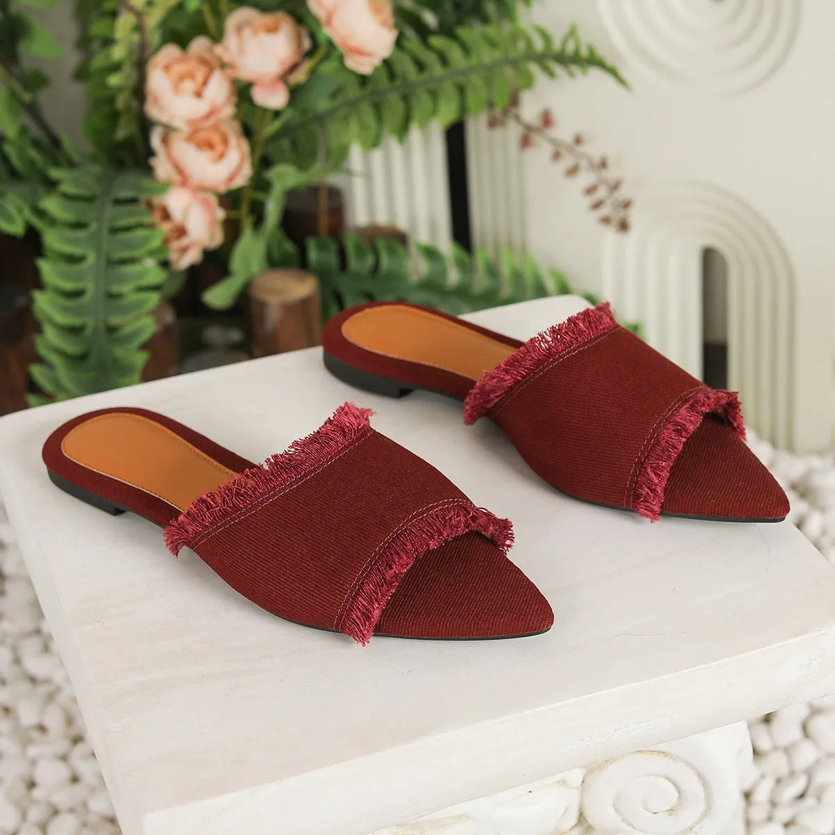 Women's denim flat slippers with a tassel detail and leather lining in a choice of colours.