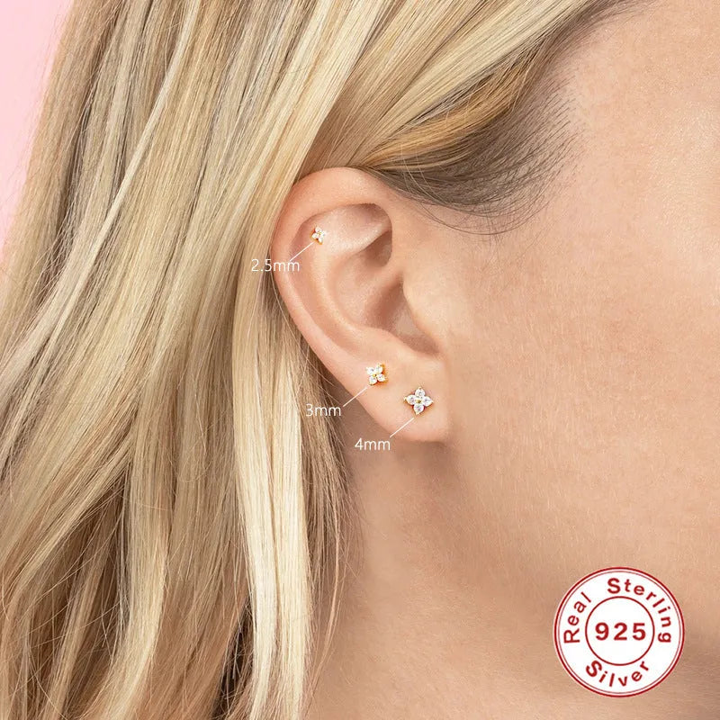 S925 sterling silver stud earrings with a geometric petal and crystal flower design in gold and platinum finishes.